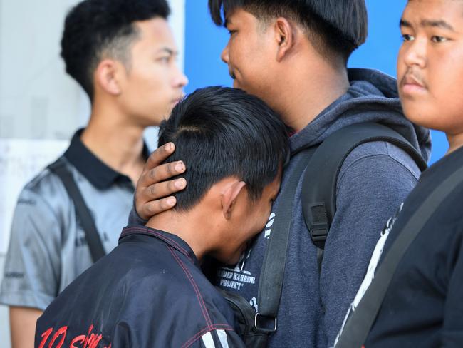 Friends of Atiwat Promsuk, who was killed in a mass shooting at the Terminal 21 shopping mall. Picture: AFP