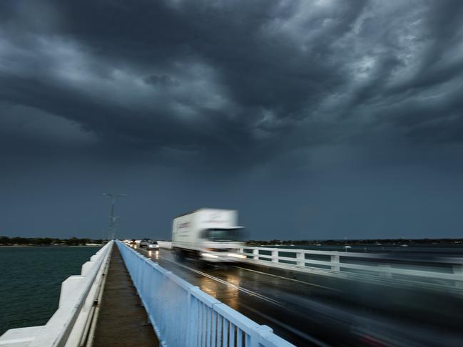 A storm cell passes over the bridge to Bribe Island as wild weather lashes south east Queensland. Photo Lachie Millard