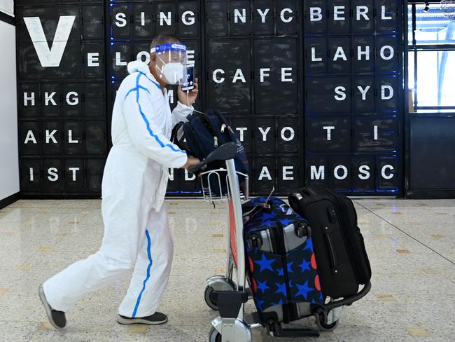 Brave new world of travel. A heavily protected man arrives at Sydney International Airport on Monday. Picture: NCA NewsWire / Jeremy Piper