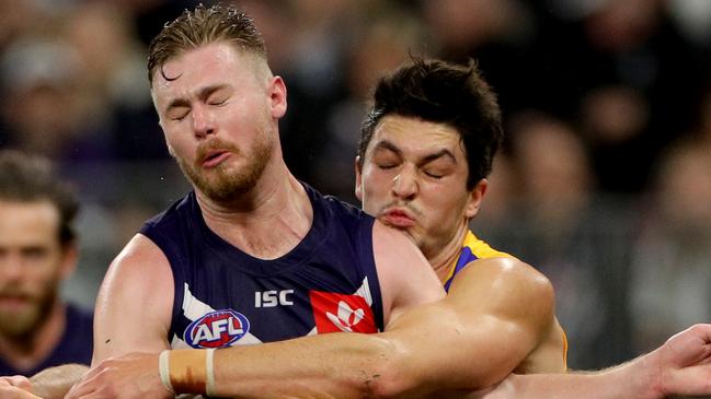 Cam McCarthy (left) of the Dockers is tackled by Tom Barrass of the Eagles during the Round 16 AFL match between the Fremantle Dockers and the West Coast Eagles at Optus Stadium in Perth, Saturday, July 6, 2019. (AAP Image/Richard Wainwright) NO ARCHIVING, EDITORIAL USE ONLY