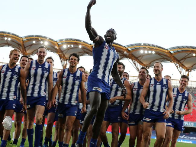 AFL Round 9. North Melbourne vs Adelaide at Metricon Stadium, Gold Coast.  01/08/2020.   Majak Daw of the Kangaroos celebrates his 1st game back as he leads the Kangaroos off Metricon Stadium   . Pic: Michael Klein