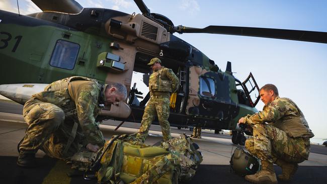 Aircrew from the Australian Army Aviation Corps and the US Army prepare for a late afternoon flight on an Australian MRH90 during Exercise Talisman Sabre 2023 near Townsville.