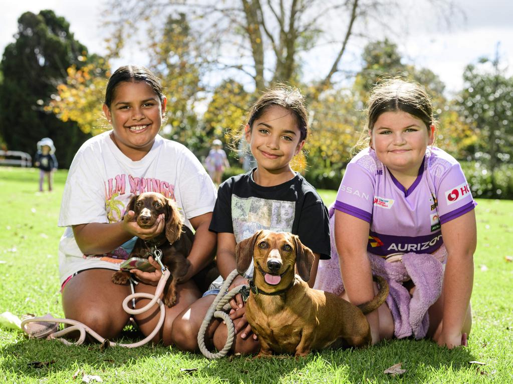 At Toowoomba's World Environment Day celebrations are (from left) Isabella Fraser, Lucia Fraser and Abby Lowe with Frankee (left) and Leo at Lake Annand Park, Sunday, June 1, 2025. Picture: Kevin Farmer