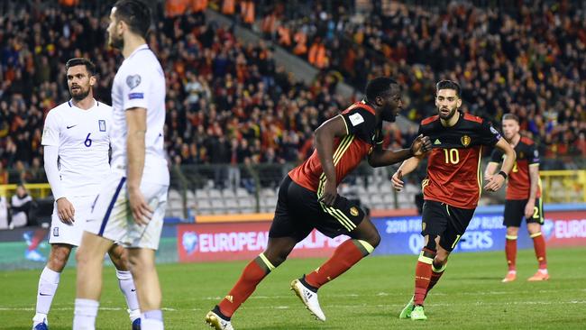 Belgium's forward Romelu Lukaku (L) celebrates after scoring.