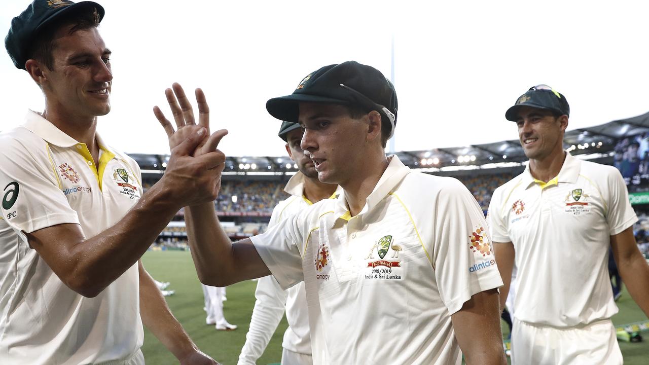 Jhye Richardson of Australia is congratulated by Pat Cummins and Mitchell Starc in Brisbane.