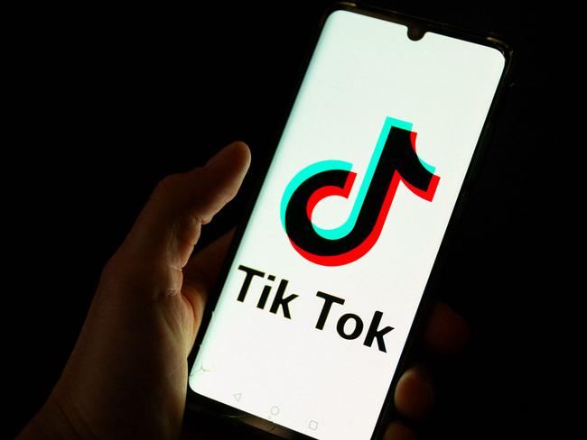 (FILES) This photograph taken on April 19, 2024 shows a man holding a smartphone displaying the logo of Chinese social media platform Tiktok in an office in Paris. TikTok faces an imminent shutdown in the United States after Congress passed a law last year forcing its Chinses owner ByteDance to either sell the platform or close it by this January 19, 2025. The US Supreme Court is expected to rule this week on TikTok's challenge to the law. (Photo by Antonin UTZ / AFP)