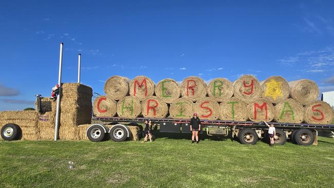 Morris Transport's hay bale display, with Deni, 8, Lila, 13, and Poppy Morris, 7. Picture: Supplied