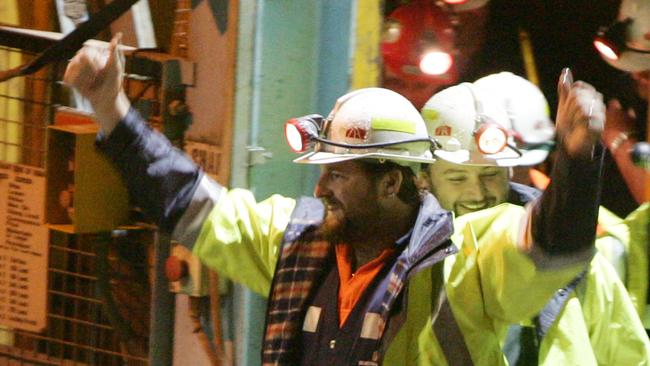 Tasmanian miners Todd Russell and Brant Webb wave as they emerge from the mine. Picture: IAN WALDIE/GETTY IMAGES