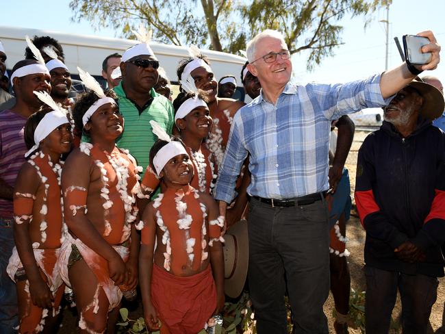 Prime Minister Malcolm Turnbull meets with a local indigenous dance troupe after his welcome at Tennant Creek airport. Picture: Dan Himbrechts