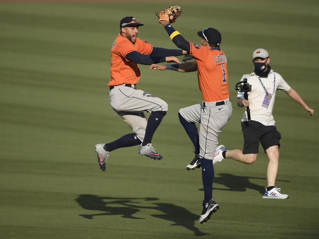 LOS ANGELES, CALIFORNIA - OCTOBER 05:  Carlos Correa #1 and George Springer #4 of the Houston Astros celebrate the teams 10-5 win against the Oakland Athletics in Game One of the American League Division Series at Dodger Stadium on October 05, 2020 in Los Angeles, California. (Photo by Kevork Djansezian/Getty Images)