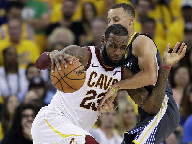 FILE - In this June 3, 2018, file photo, Cleveland Cavaliers forward LeBron James (23) drives against Golden State Warriors guard Stephen Curry during the first half of Game 2 of basketball's NBA Finals in Oakland, Calif. James is signing as a free agent with the Los Angeles Lakers, leaving the Cavaliers for the second time to join one of the NBAâ€™s most iconic franchises. James made the announcement Sunday, July 1, 2018, on a release, saying he has agreed to a four-year, $154 million contract. (AP Photo/Marcio Jose Sanchez, File)