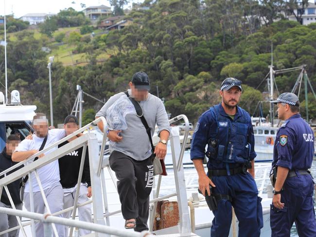 Police in Eden, on the NSW south coast with passengers from the Carnival Legend.