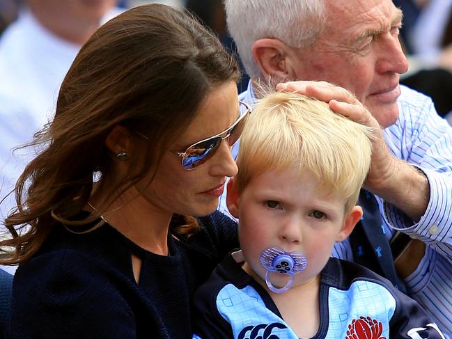 Sarah Vickerman with younger son Xavier and her Father at Dan Vickerman's Memorial service on the Number 1 Oval at Sydney University. pic Mark Evans