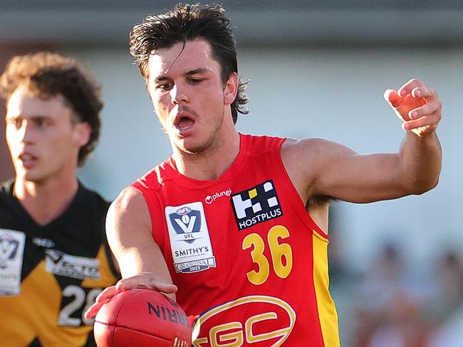 MELBOURNE, AUSTRALIA - SEPTEMBER 24: Elijah Hollands of the Suns kicks the ball during the VFL Grand Final match between Gold Coast Suns and Werribee at Ikon Park on September 24, 2023 in Melbourne, Australia. (Photo by Kelly Defina/AFL Photos/via Getty Images)