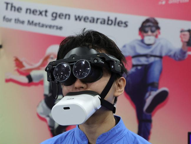 LAS VEGAS, NEVADA - JANUARY 03: Tomohiko Fukaya demonstrates Shiftallâs full-body tracking device, including the mutalk Bluetooth microphone over his mouth and the MeganeX VRE headset with an HDR micro OLED display, for playing VR in the metaverse during a press event at CES 2023 at the Mandalay Bay Convention Center on January 03, 2023 in Las Vegas, Nevada. CES, the worldâs largest annual consumer technology trade show, runs from January 5-8 and features about 3,100 exhibitors showing off their latest products and services to more than 100,000 attendees.   Ethan Miller/Getty Images/AFP (Photo by Ethan Miller / GETTY IMAGES NORTH AMERICA / Getty Images via AFP)