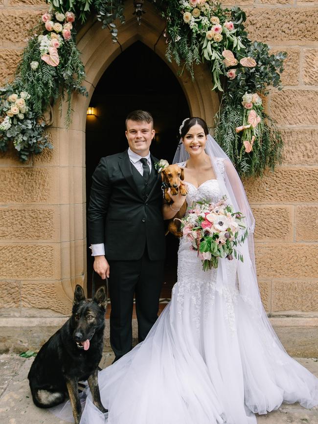 Jodie Nixon and Joss Maybury with dogs Odin, left, and Hunter on their wedding day. Picture: Clarzzique