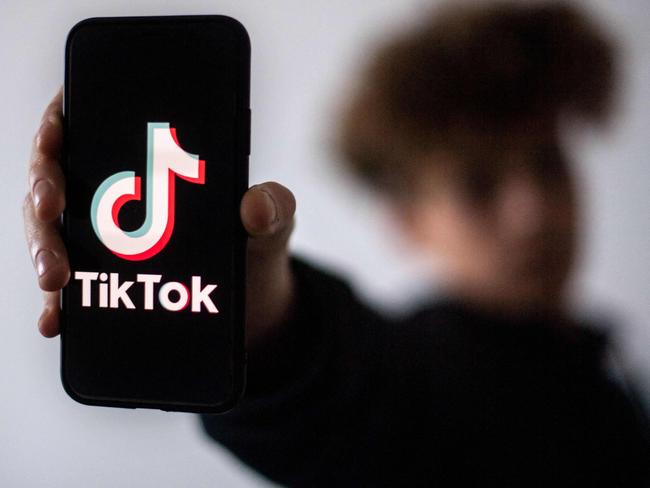 (FILES) In this file photo taken on January 21, 2021 a teenager presents a smartphone with the logo of Chinese social network Tik Tok in Nantes, western France. - Leaders of the US Senate Intelligence Committee on Tuesday called for an investigation into whether Chinese officials are getting access to data about US users of video-snippet sharing sensation TikTok. (Photo by LOIC VENANCE / AFP)