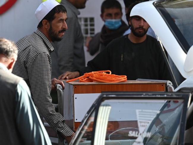 Relatives load the coffin of a suicide bombing victim into a car on August 27, 2021. Picture: Aamir Qureshi / AFP.