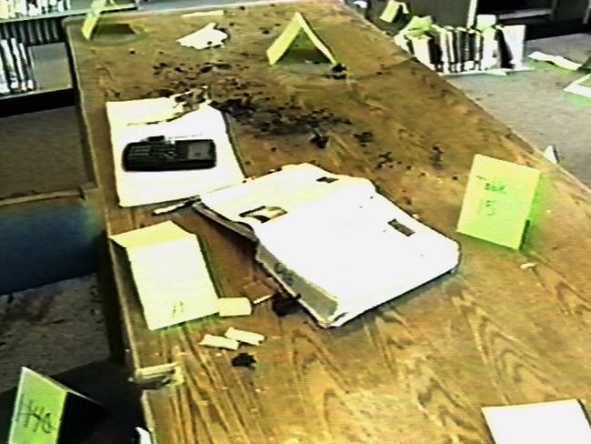 Yellow evidence tags on a desk in the library at Columbine High School after the massacre.