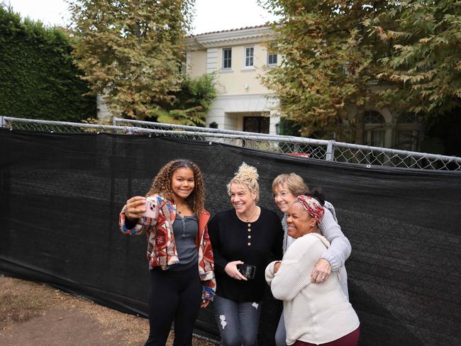 A group takes a selfie outside the Menendez death house, which has become a macabre drawcard for tourists in Beverly Hills. Picture: AFP