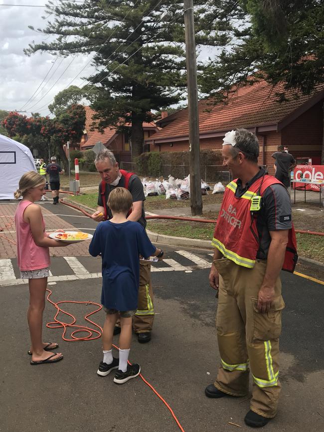 Local kids Zoe and Lenny bring out snacks to the firies outside Sandringham Primary School.