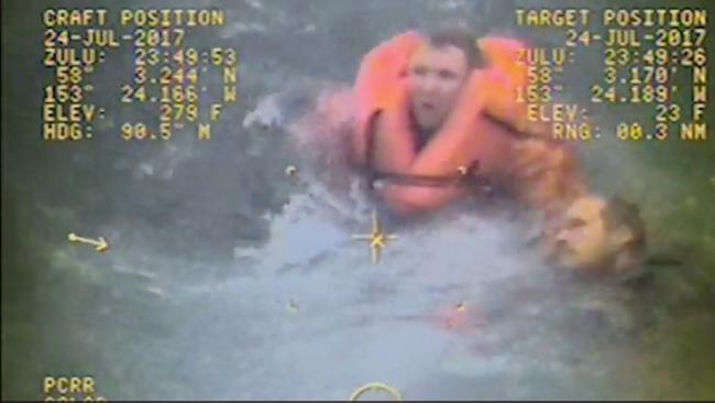 <s1>In this still image from video taken by the Alaska Coast Guard, the captain of the fishing vessel <i>Grayling</i>, left, rescues one of his crewmen after the vessel capsized in the Kupreanof Strait near Raspberry Island, Alaska</s1>. <source>Picture: US COAST GUARD via AP</source>                                             <source/>