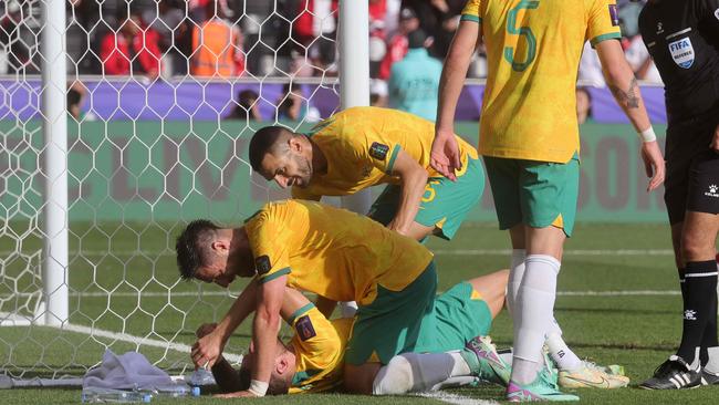 Australia's forward #06 Martin Boyle (bottom) celebrates with teammates after scoring his team's second goal during the Qatar 2023 AFC Asian Cup football match between Australia and Indonesia at the Jassim bin Hamad Stadium in Doha on January 28, 2024. (Photo by Giuseppe CACACE / AFP)