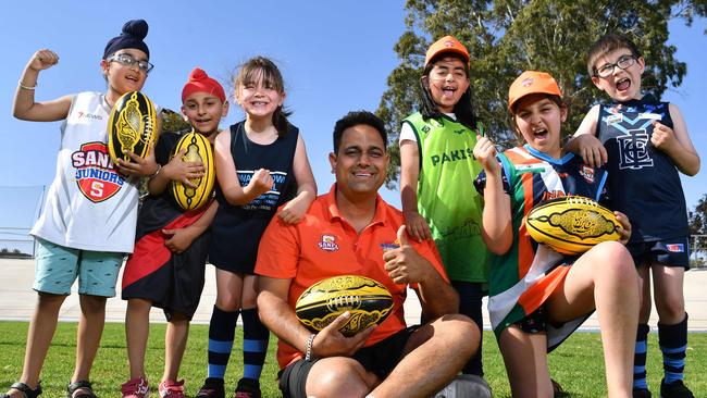 Coach Deepak Bhardwaj with (from left) Paalvee, Samrath, Tilly, Mariyam, Ekam and Rory at Edwardstown Football club for the Welcome to Australian Rules football program at the club. Picture: AAP/Keryn Stevens