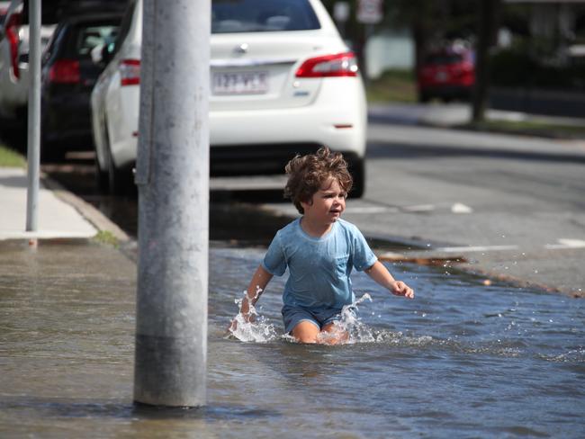 Flooding from the King tide at Budds Beach at Surfers Paradise was made worse by the approaching storm system. Locals Alberto Scuteri 4 enjoys the water , not so his parents. Picture Glenn Hampson
