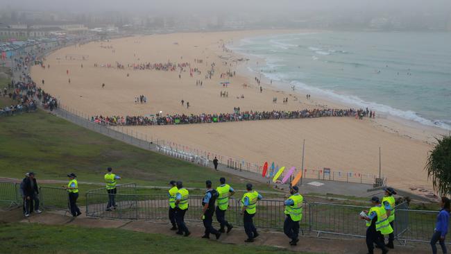 Crowds gather on Bondi Beach as police arrive ahead of Royal visit.  Picture: Toby Zerna