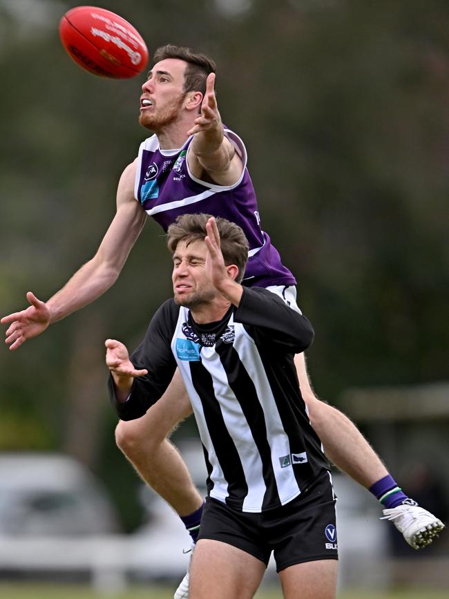 VAFA: Brunswick’s Aidan Pollock jumps over Ivanhoe’s Luke Course. Picture: Andy Brownbill