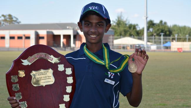 Ashley Chandrasinghe celebrates winning gold in the under 12 Victorian cricket team.