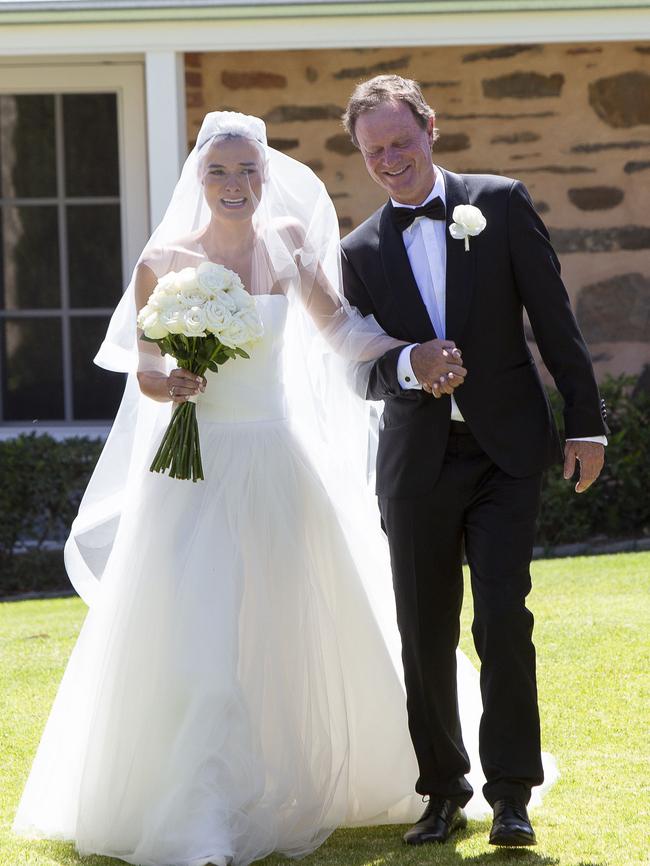 Father Adrian Swale walks daughter Chloe Swale down the aisle. Picture: Brett Hartwig