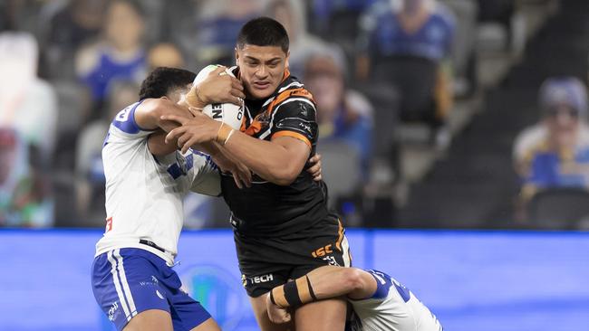 Tommy Talau of the Tigers is tackled during the Round 7 NRL match between the Canterbury-Bankstown Bulldogs and the Wests Tigers at Bankwest Stadium in Sydney, Sunday, June 28, 2020. (AAP Image/Craig Golding) NO ARCHIVING, EDITORIAL USE ONLY