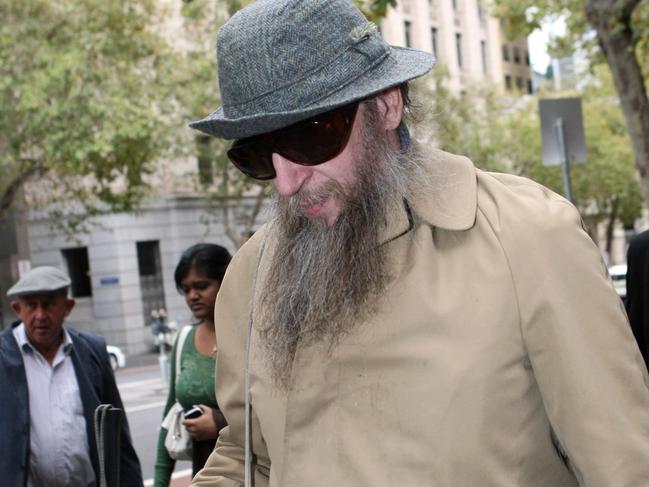 Robin Fletcher outside the Supreme Court. Self-proclaimed black magic sex witch. Fletcher will be placed under strict monitoring for the next five years with a ban on contact with children and restrictions on his religious practice. Fletcher, 54, served more than 10 years in jail for raping and prostituting two 15 year old girls. (Fletcher appeared to struggle down the stairs, NOTE - later in the morning we photographed him with a very normal gait as he strolled through the city with his two minders...SEE SECOND PIC).