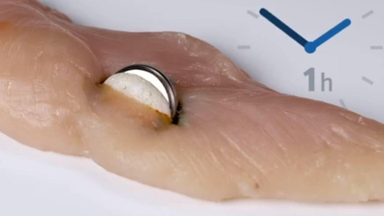 Qld Health video showing how quickly button batteries can cause harm. Pictured: 1 hr damage to a chicken fillet.