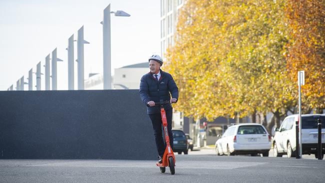 Premier of Tasmania Peter Gutwein rides an electric scooter to a press conference regarding a trial of e-scooters in Hobart, at Princes Wharf No. 1, the day before the 2021 Tasmanian State Election on Saturday 1st May. Picture: NCA NewsWire / Richard Jupe