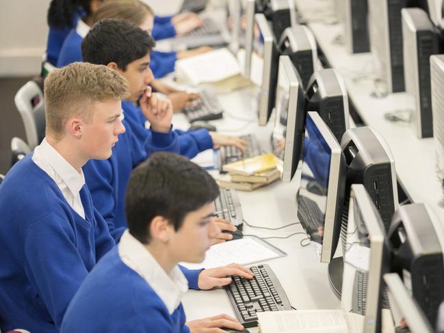 Schools of excellence - teenage students using computers in computer room.