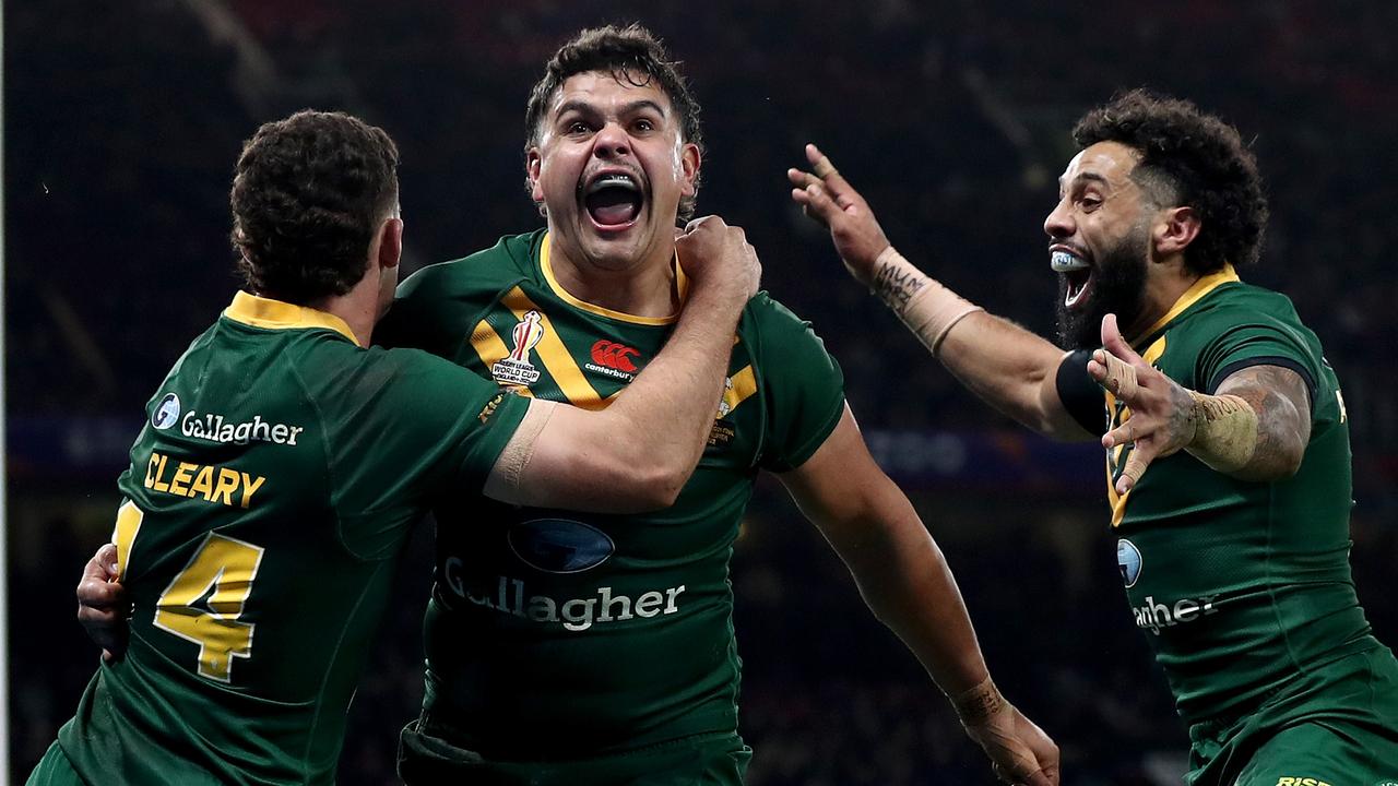 MANCHESTER, ENGLAND - NOVEMBER 19: Latrell Mitchell of Australia celebrates with teammates Nathan Cleary and Josh Addo-Carr after scoring their team's sixth try during the Rugby League World Cup Final match between Australia and Samoa at Old Trafford on November 19, 2022 in Manchester, England. (Photo by George Wood/Getty Images)