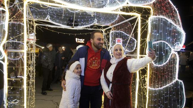 People enjoy New Year's Eve celebrations at Christmas Market in Damascus. Picture: Getty