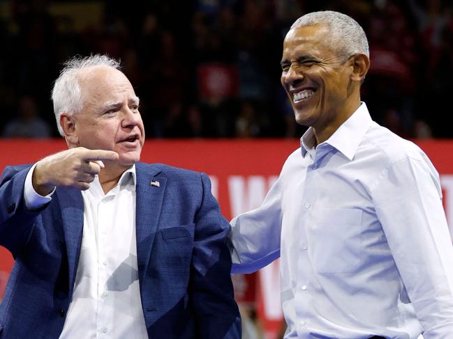 Minnesota Governor and Democratic vice presidential candidate Tim Walz (L) gestures toward former US President Barack Obama after speaking during a campaign rally in support of Vice President and Democratic presidential candidate Kamala Harris, at Alliant Center in Madison, Wisconsin, on October 22, 2024. (Photo by KAMIL KRZACZYNSKI / AFP) / ALTERNATE CROP