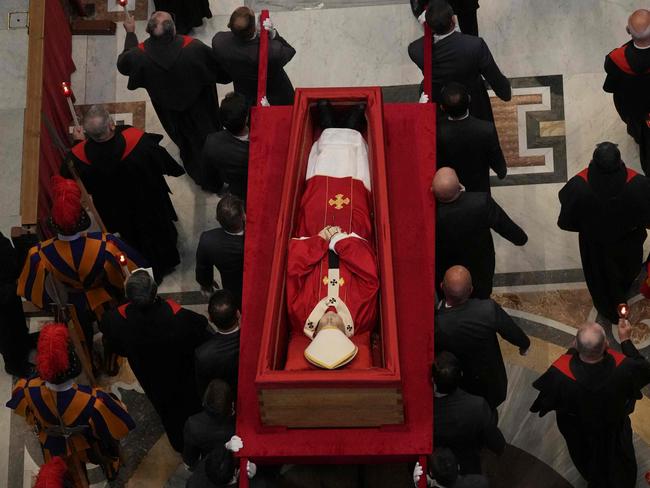 The body of Pope Francis is carried into St. Peterâs Basilica where he will lie in state for three days, at the Vatican on April 23, 2025. The Pope died of a stroke, the Vatican announced hours after the death on April 21, 2025, of the 88-year-old reformer who inspired devotion but riled traditionalists during 12 years leading the Catholic Church. (Photo by Andrew Medichini / POOL / AFP)