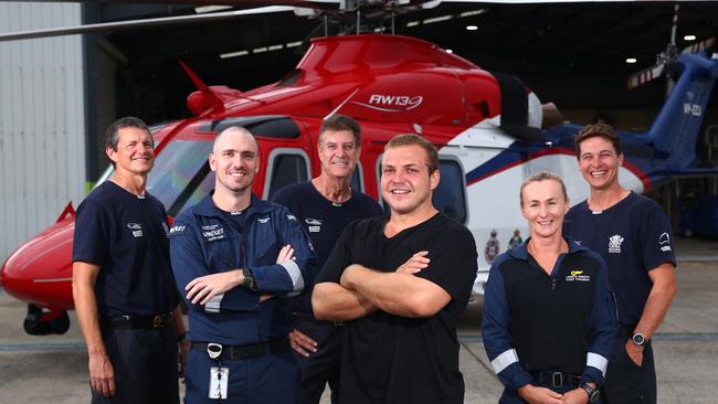 Craig Simpson is lucky to be alive after falling from Emerald Creek Falls. (L-R) air crewmen Darrin Evans, retrieval doctor Shaun Francis, rescue pilot Phil Frost, flight paramedic Lauretta Howarth and rescue crew Marty Dahlstrom at Cairns Airport. Picture: Brendan Radke