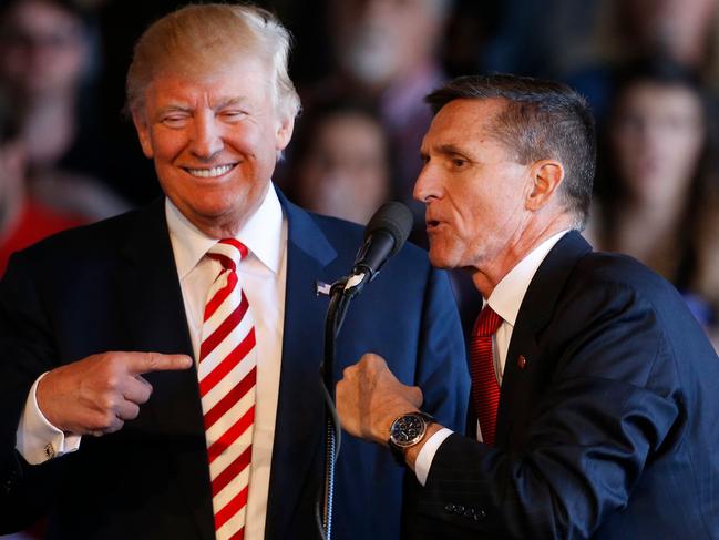 Former Republican presidential candidate Donald Trump as he jokes with retired Gen. Michael Flynn in 2016. Picture: Getty