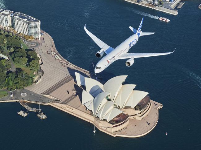 SYDNEY, AUSTRALIA - MAY 02: An Airbus A350-1000 flight test aircraft flies over Sydney Harbour to mark a major fleet announcement by Australian airline Qantas on May 02, 2022 in Sydney, Australia. Twelve Airbus A350-1000's will be ordered to operate non-stop "Project Sunrise" flights from Australia's east coast to New York, London and other key destinations. The aircraft will feature market-leading passenger comfort in each travel class with services to start by the end of 2025. (Photo by James D. Morgan/Getty Images for Airbus/Qantas) *** BESTPIX ***