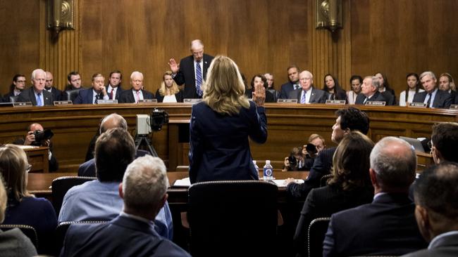 Christine Blasey Ford is sworn in by Senate Judiciary Committee chairman Chuck Grassley, R-Iowa, to testify before the Senate Judiciary Committee on Capitol Hill in Washington, Thursday, Sept. 27, 2018.  (Tom Williams/Pool Photo via AP)