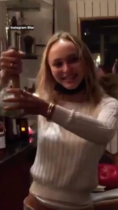 Lily-Rose Depp mixes drinks at Paris bar where brother works