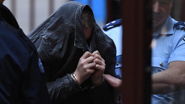 Jaymes Todd covered his face with his jacket as he was lead into the Supreme Court. Picture: AAP