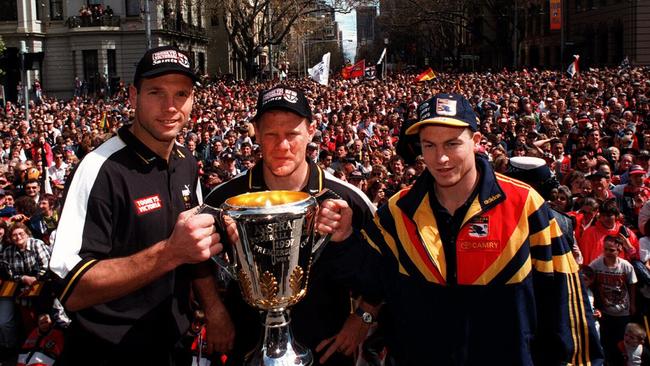 Stewart Loewe posed with teammate Nathan Burke and Adelaide Crows skipper Mark Bickley during the 1997 AFL grand final parade through Melbourne.