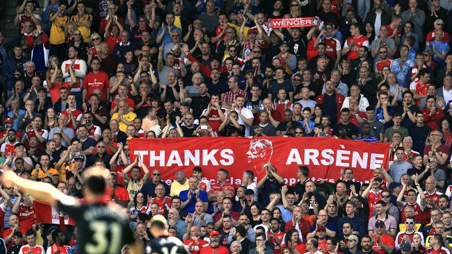 Arsenal fans carry banners supporting outgoing manager Arsene Wenger in the stands